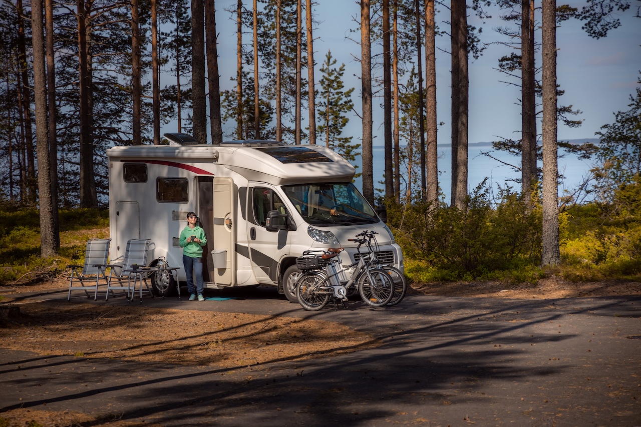 woman on vacation standing outside rv 